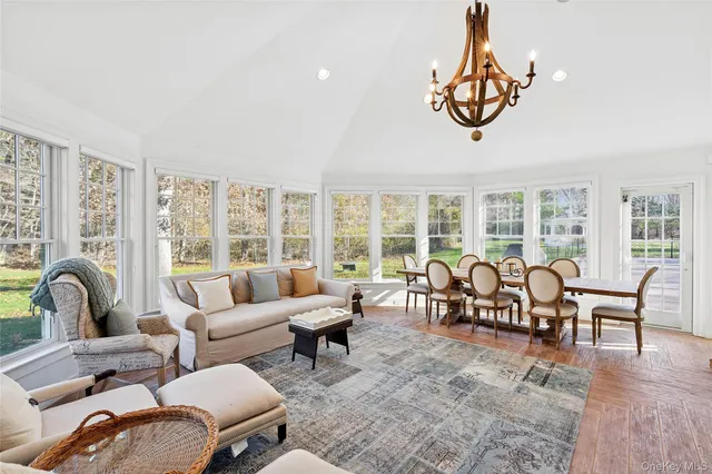 a living room with furniture and floor to ceiling windows