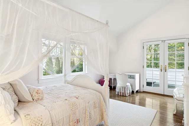 a bed room with a bed and a large window