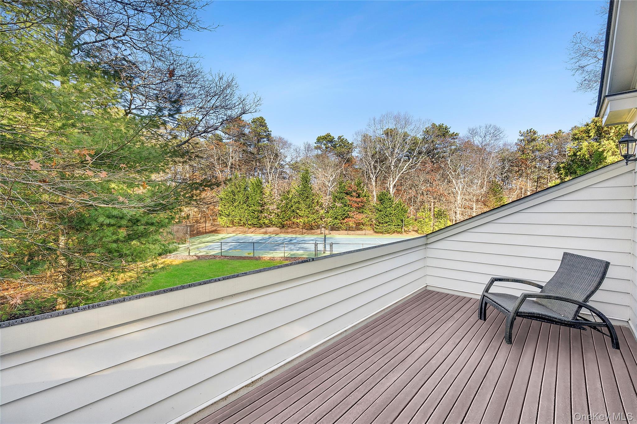 8 East Ridge Court Westhampton, NY 11977 - Photo 21 of 32 a view of balcony with furniture and wooden floor
