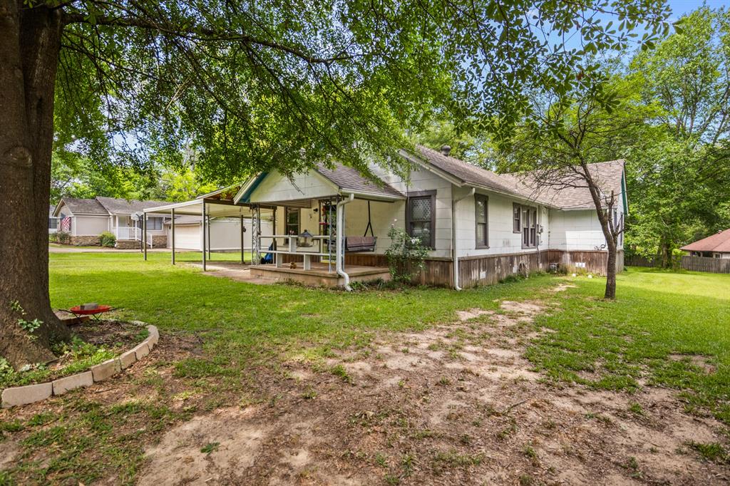103 South Sun Camp Road White Oak, TX 75693 - Photo 5 of 40 a view of a house with backyard and a tree