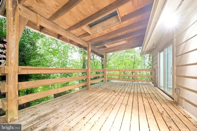 a view of balcony with wooden floor and fence