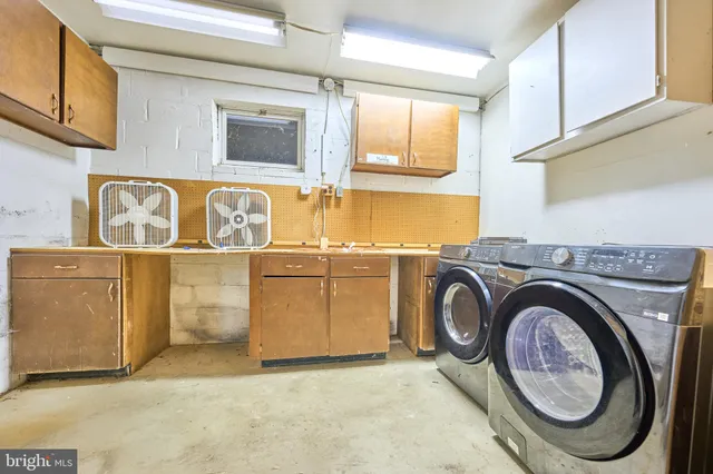 a utility room with sink dryer and washer