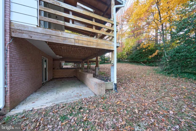 a view of a patio with table and chairs under an umbrella