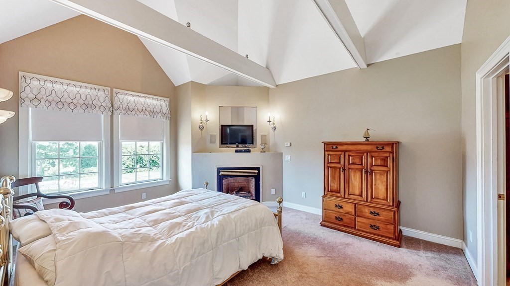 290 Three Rivers Road Wilbraham, MA 01095 - Photo 17 of 42 a spacious bedroom with a bed and a fireplace
