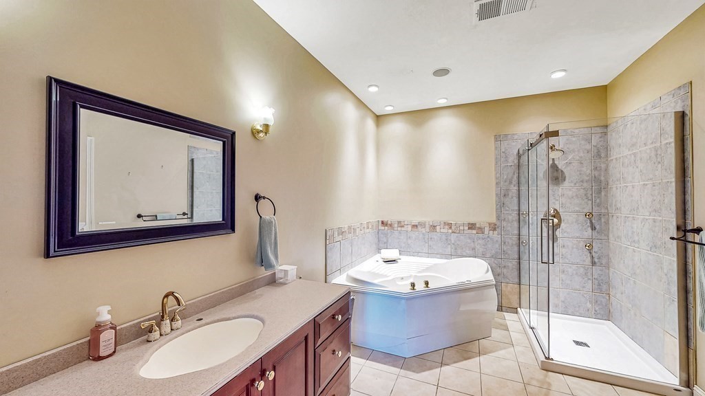 290 Three Rivers Road Wilbraham, MA 01095 - Photo 21 of 42 a bathroom with a tub sink mirror and toilet