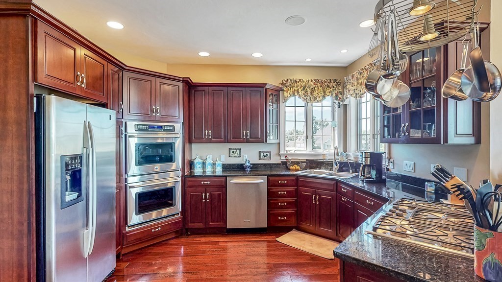 290 Three Rivers Road Wilbraham, MA 01095 - Photo 8 of 42 a kitchen with stainless steel appliances granite countertop a refrigerator a sink dishwasher a stove and white cabinets with wooden floor