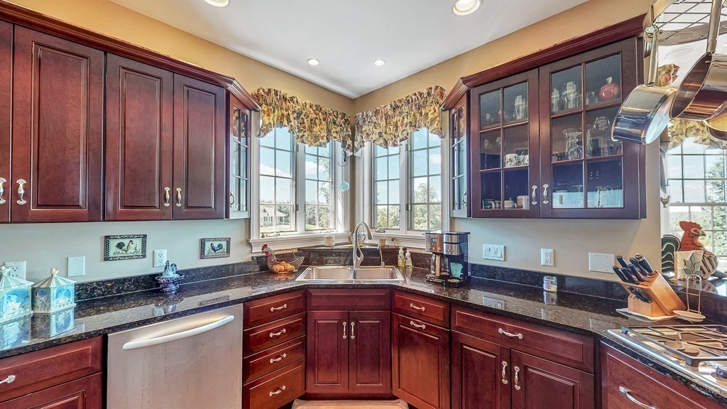 290 Three Rivers Road Wilbraham, MA 01095 - Photo 9 of 42 a kitchen with granite countertop wooden cabinets a sink and dishwasher