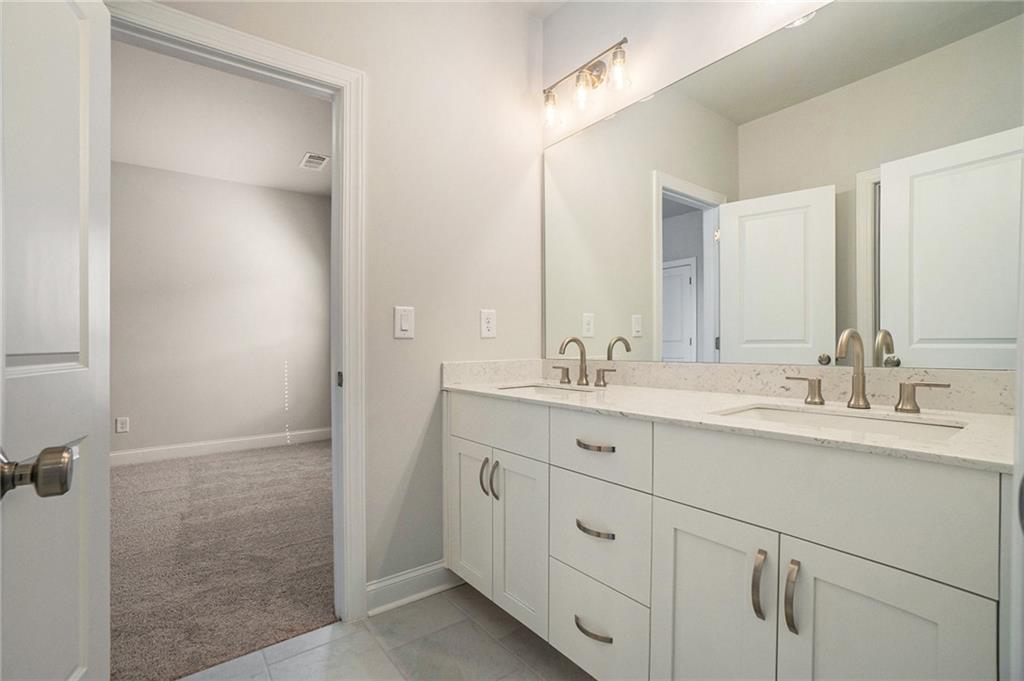 106 Basil Street Cumming, GA 30040 - Photo 17 of 25 a bathroom with a double vanity sink mirror and