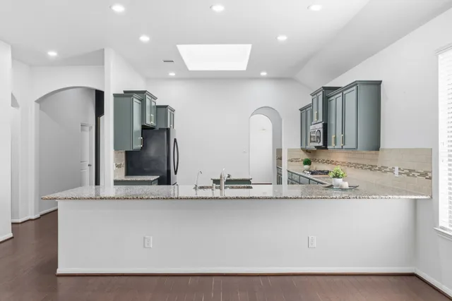 a kitchen with stainless steel appliances granite countertop a sink and dishwasher with cabinets