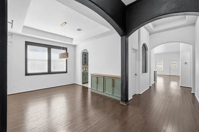 a view of a kitchen with a sink a fireplace and wooden floor