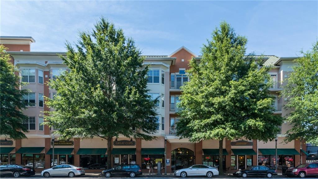 a front view of a building with trees