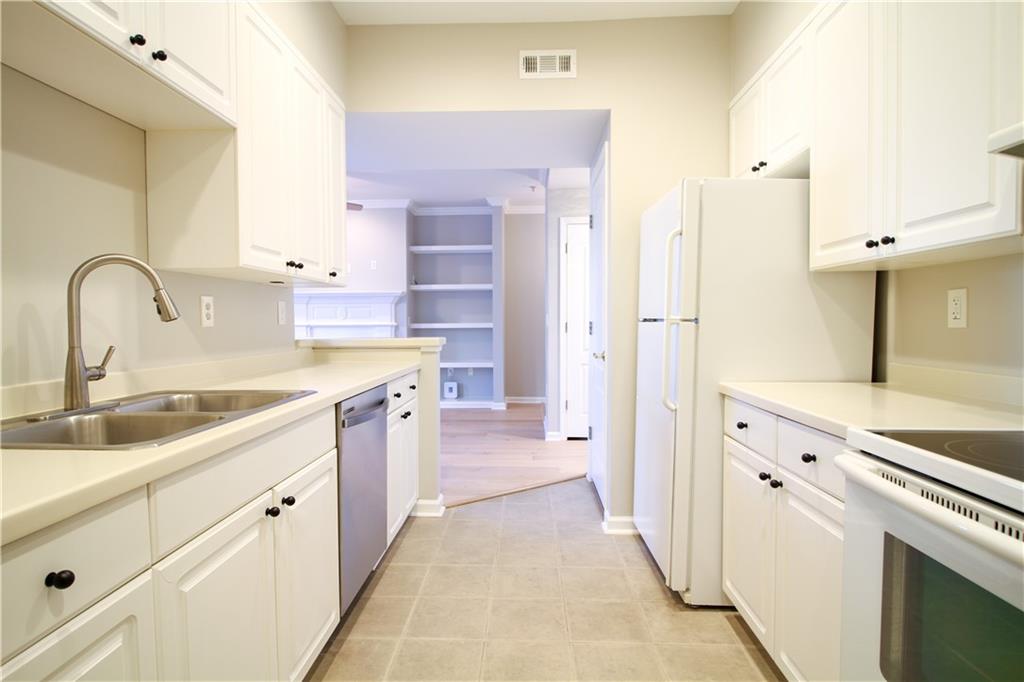 225 East Ponce De Leon Avenue, Unit 325 Decatur, GA 30030 - Photo 11 of 34 a kitchen with a sink stove and refrigerator
