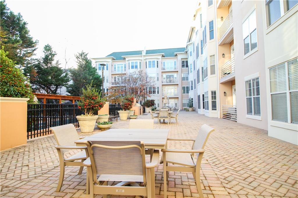 225 East Ponce De Leon Avenue, Unit 325 Decatur, GA 30030 - Photo 21 of 35 a view of a dinning table and chairs in the patio