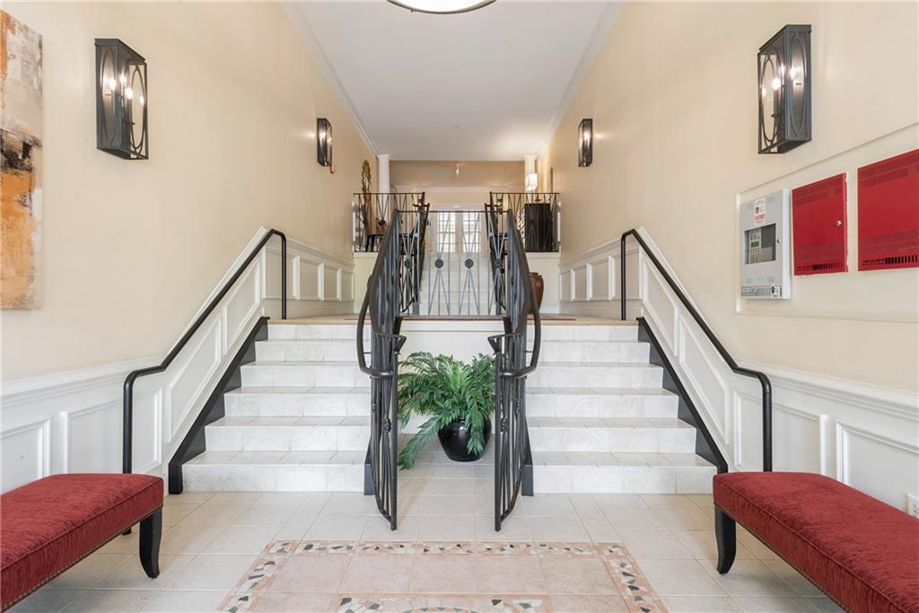 225 East Ponce De Leon Avenue, Unit 325 Decatur, GA 30030 - Photo 26 of 34 a view of staircase with furniture and a mirror