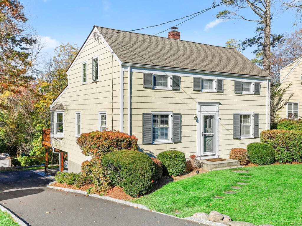 197 Hollow Tree Ridge Road Darien, CT 06820 - Photo 20 of 24 a front view of a house with a yard and garage