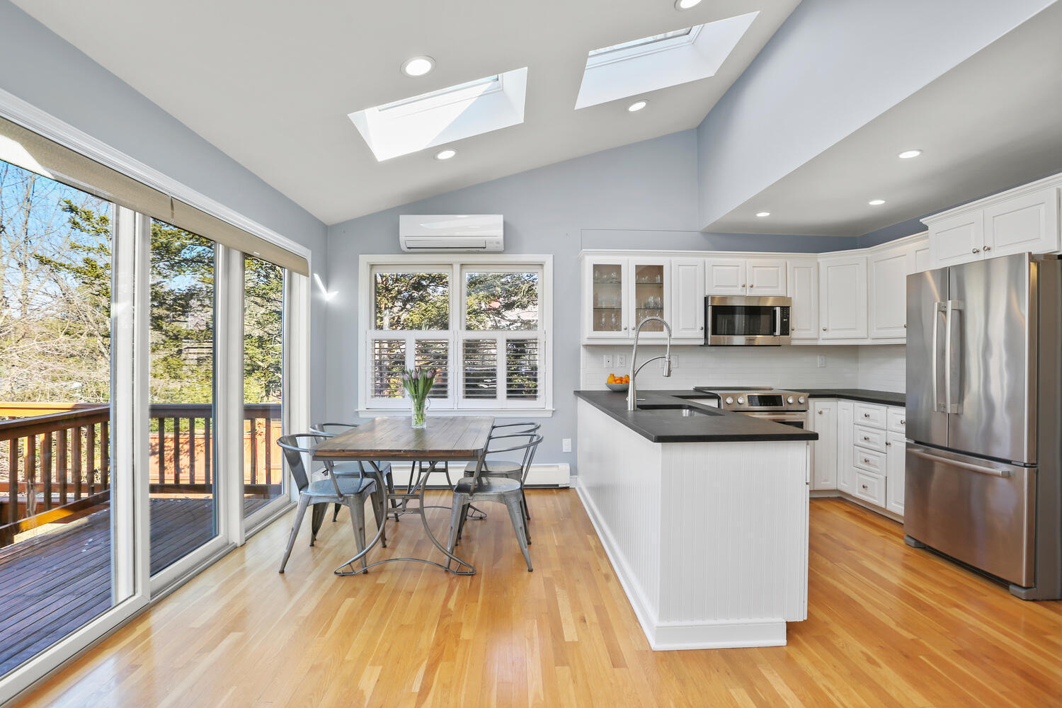 197 Hollow Tree Ridge Road Darien, CT 06820 - Photo 6 of 24 a kitchen with stainless steel appliances a stove a refrigerator a kitchen island a stove a refrigerator a dining table and chairs with wooden floor