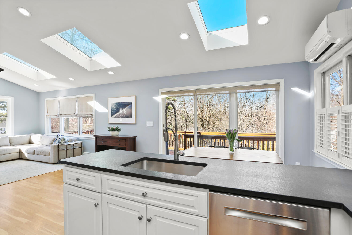 197 Hollow Tree Ridge Road Darien, CT 06820 - Photo 8 of 24 a open kitchen with stainless steel appliances granite countertop a sink a stove and white cabinets with wooden floor