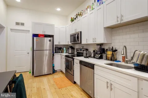 a kitchen with a refrigerator and a sink