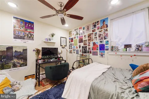 a bedroom with a bed a couch and dresser