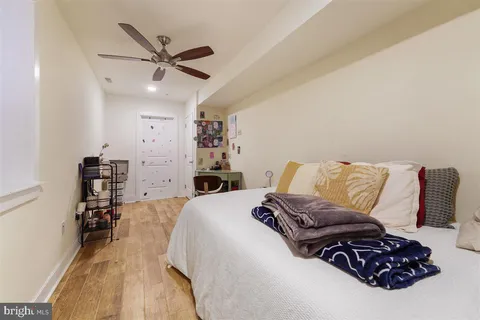 a living room with a bed furniture and a chandelier