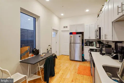 a kitchen with refrigerator and table