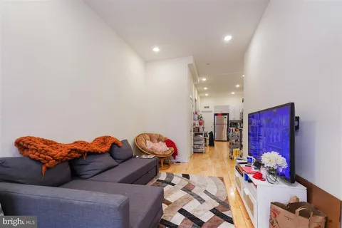 a living room with furniture chess board and couch