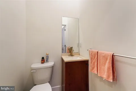 a bathroom with a toilet sink and mirror