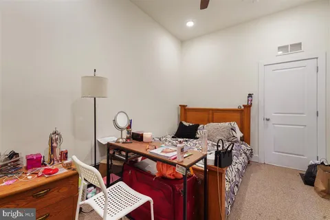 a bedroom with a bed and a dresser in it