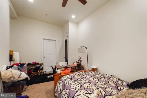 a bedroom with furniture and a chandelier