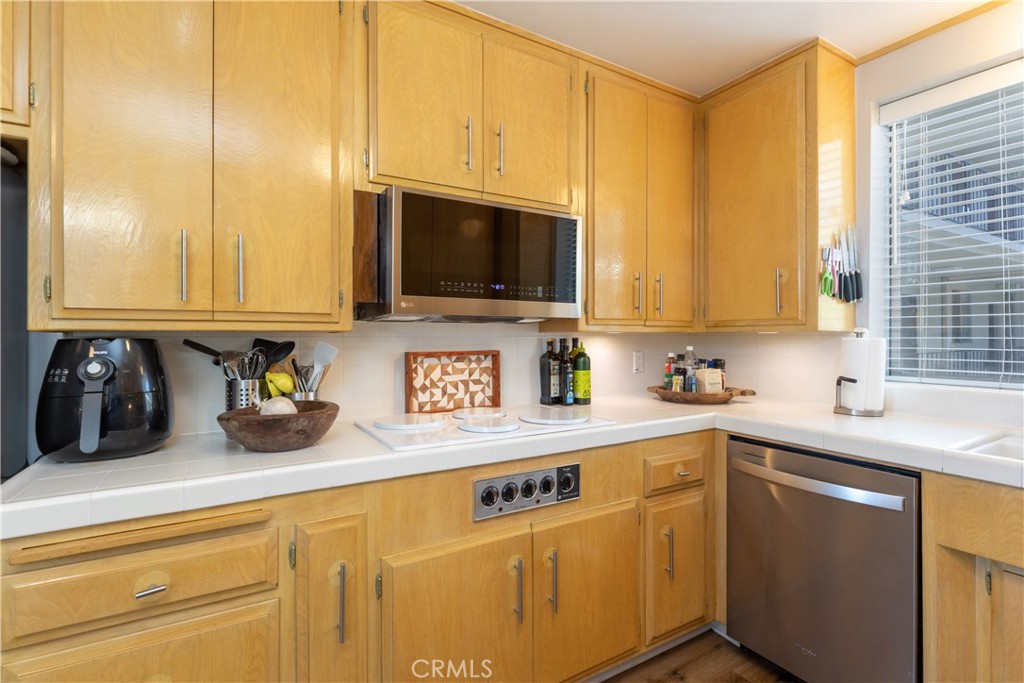 2772 2nd Street, Unit 2G Long Beach, CA 90803 - Photo 13 of 53 a kitchen with stainless steel appliances granite countertop a sink a stove and cabinets