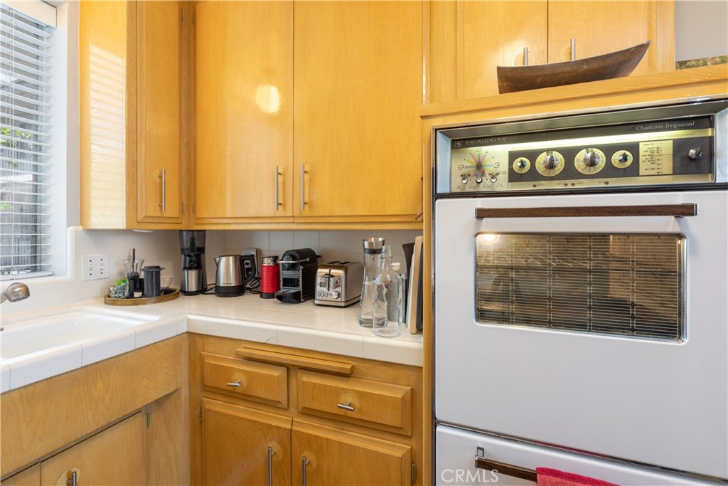 2772 2nd Street, Unit 2G Long Beach, CA 90803 - Photo 14 of 53 a kitchen with a stove and a white cabinets