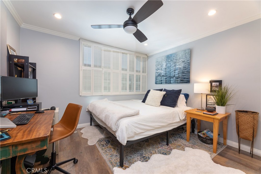2772 2nd Street, Unit 2G Long Beach, CA 90803 - Photo 17 of 53 a bedroom with a bed a chair and a chandelier