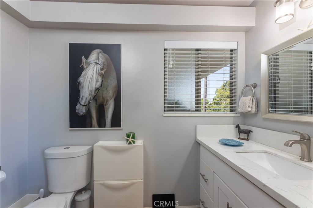 2772 2nd Street, Unit 2G Long Beach, CA 90803 - Photo 24 of 53 a bathroom with a sink a toilet and a mirror