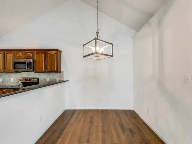 a view of a microwave and a wooden floor