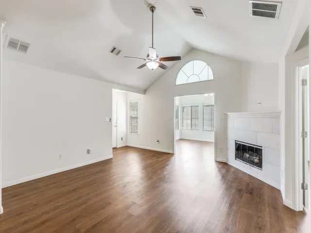 a view of livingroom with fireplace wooden floor and window