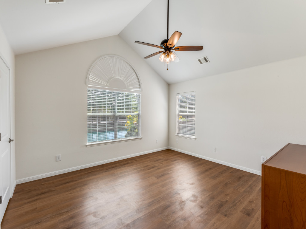 30 Wildwood Drive, Unit 174 Georgetown, TX 78633 - Photo 22 of 34 an empty room with wooden floor fan and windows