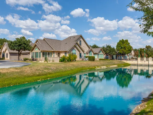 an aerial view of residential houses with outdoor space and swimming pool