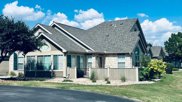 a view of a house with a yard and sitting area
