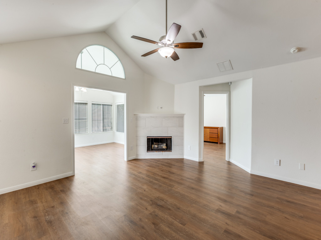 30 Wildwood Drive, Unit 174 Georgetown, TX 78633 - Photo 7 of 34 an empty room with wooden floor fireplace and windows