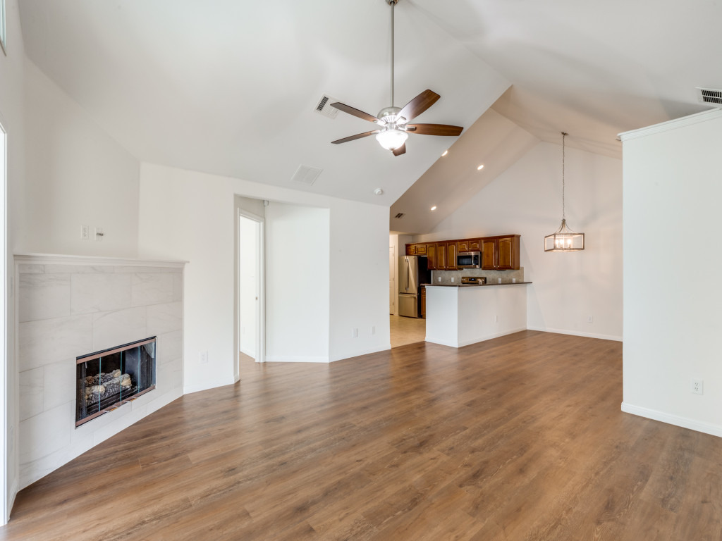 30 Wildwood Drive, Unit 174 Georgetown, TX 78633 - Photo 8 of 34 a view of an empty room with wooden floor a fireplace and a window