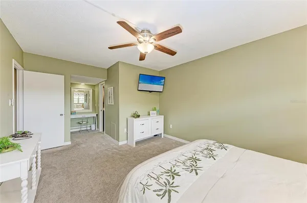 a bedroom with a bed and a ceiling fan