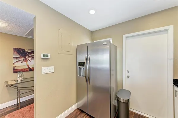 a metallic refrigerator freezer sitting in a kitchen