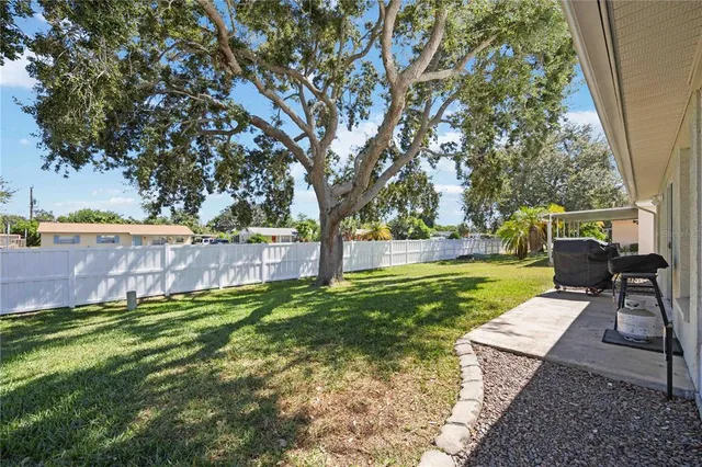 a view of yard with swimming pool and seating space