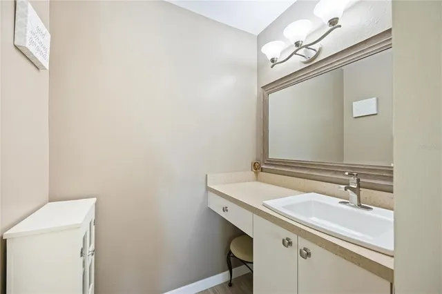 a bathroom with a sink a vanity and a mirror
