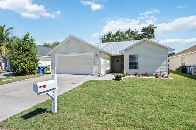 a front view of house with yard and green space