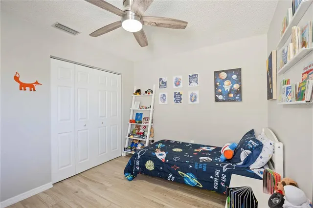 a bedroom with furniture and wooden floor
