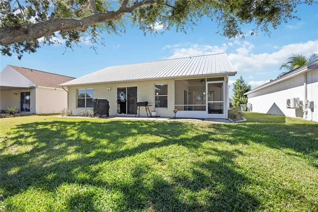 a view of a house with a backyard porch and sitting area