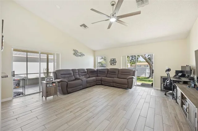 a living room with furniture and a wooden floor