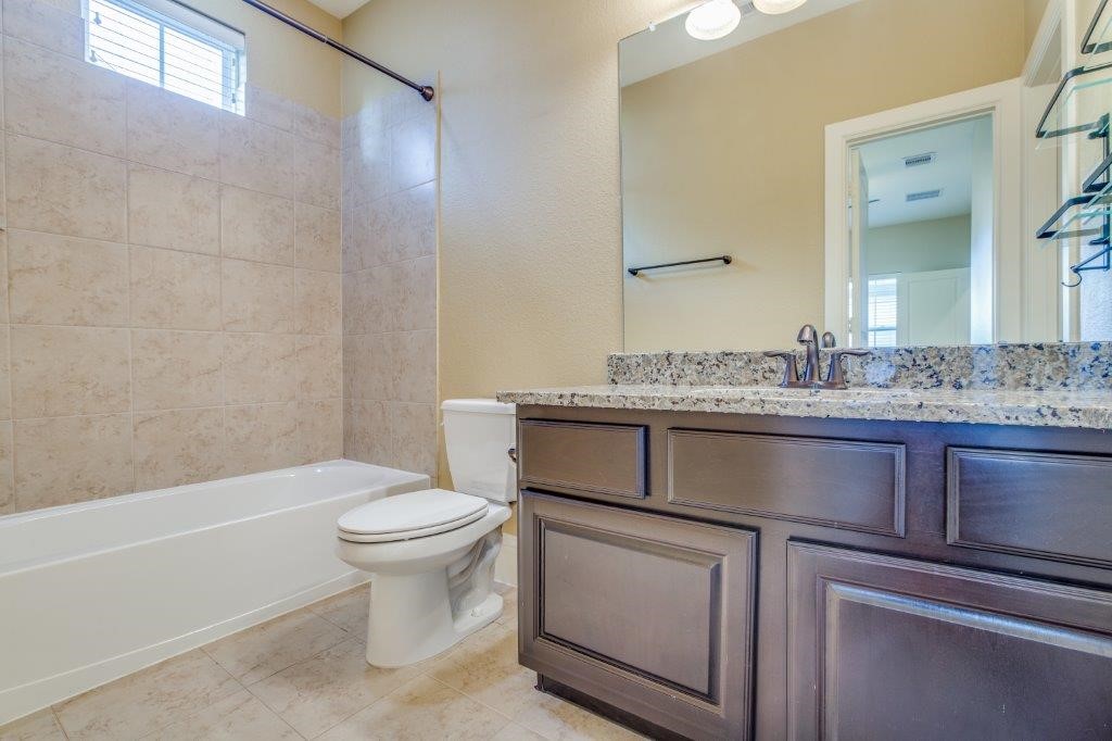 46 East Rafters Row The Woodlands, TX 77380 - Photo 18 of 25 Beautiful full bath with granite vanity and tiled tub/shower combination.