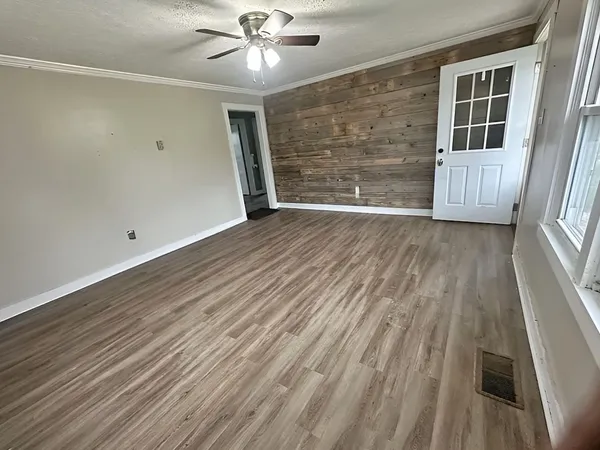 wooden floor in an empty room with a window